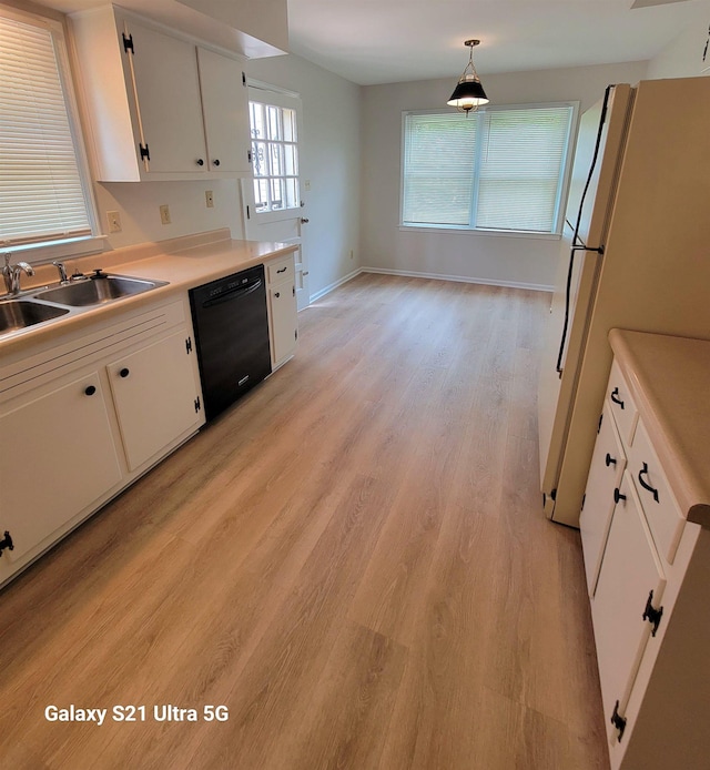 5551 Derron Dr, Memphis, TN 38115 - kitchen with black dishwasher, freestanding refrigerator, a sink, and white cabinets