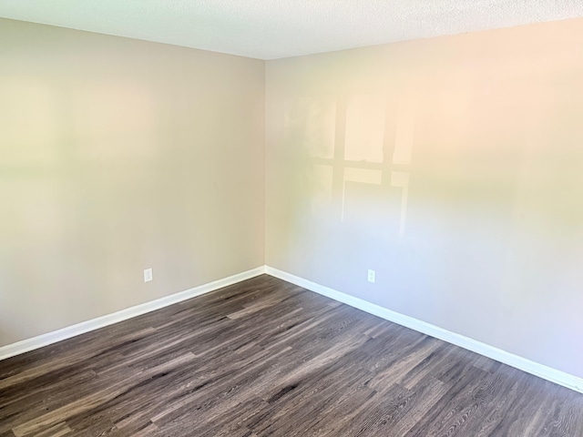 3170 Harvester Ln, Memphis, TN 38127 - empty room with dark wood-style flooring and baseboards