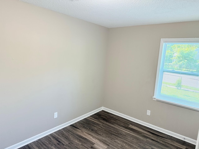 3170 Harvester Ln, Memphis, TN 38127 - empty room with dark wood finished floors, plenty of natural light, baseboards, and a textured ceiling