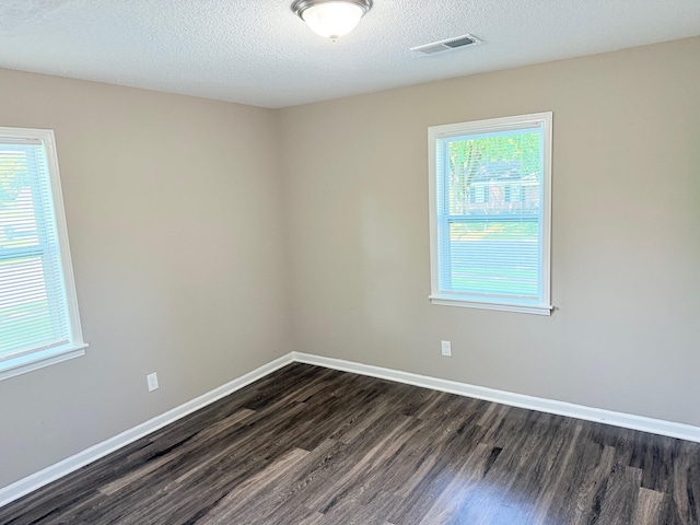 3170 Harvester Ln, Memphis, TN 38127 - spare room with dark wood-type flooring, healthy amount of natural light, baseboards, and a textured ceiling