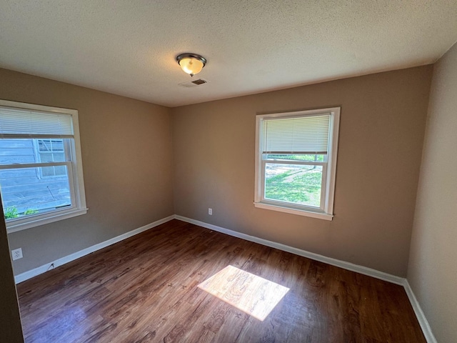 1591 Michael St, Memphis, TN 38111 - unfurnished room with healthy amount of natural light, wood finished floors, a textured ceiling, and baseboards