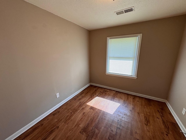 1591 Michael St, Memphis, TN 38111 - empty room featuring wood finished floors, baseboards, and a textured ceiling