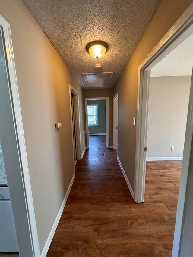 1591 Michael St, Memphis, TN 38111 - hall featuring attic access, a textured ceiling, wood finished floors, and baseboards