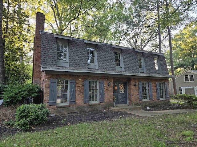 137 Perkins Ext, Memphis, TN 38117 - view of property with a chimney, roof with shingles, and brick siding