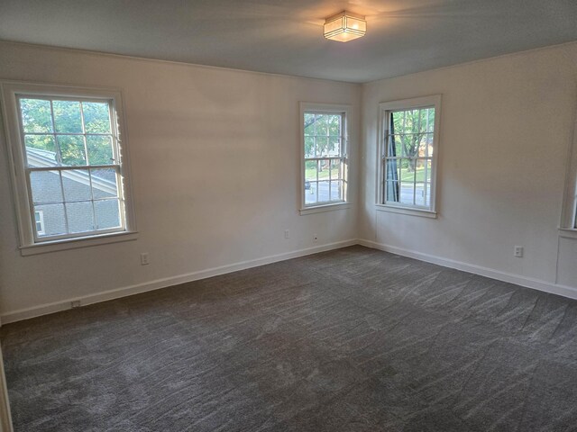137 Perkins Ext, Memphis, TN 38117 - unfurnished room with dark colored carpet and baseboards