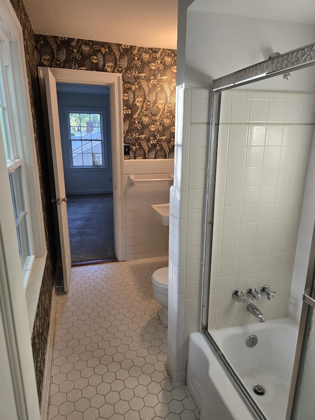 137 Perkins Ext, Memphis, TN 38117 - full bathroom featuring wallpapered walls, a wainscoted wall, toilet, tile patterned flooring, and bathing tub / shower combination