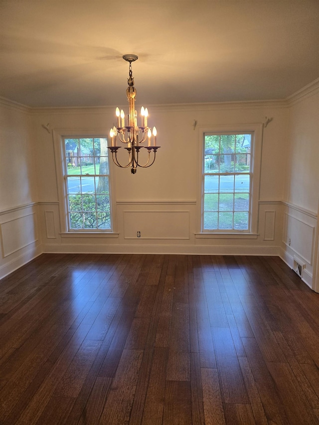 137 Perkins Ext, Memphis, TN 38117 - unfurnished room featuring plenty of natural light, a chandelier, dark wood-type flooring, a decorative wall, and wainscoting