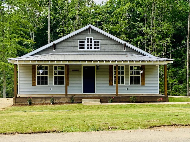 5184 Ramer Selmer Rd, Selmer, TN 38375 - view of front of property with a porch, a front yard, and metal roof