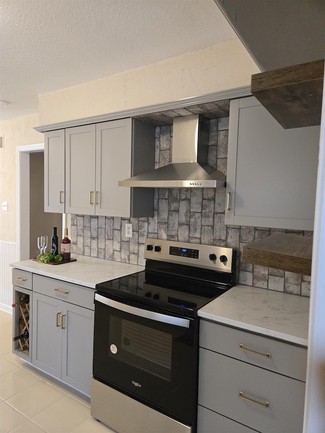 3403 Lynchburg St, Memphis, TN 38134 - kitchen with electric range oven, gray cabinets, wall chimney exhaust hood, tasteful backsplash, and a textured ceiling
