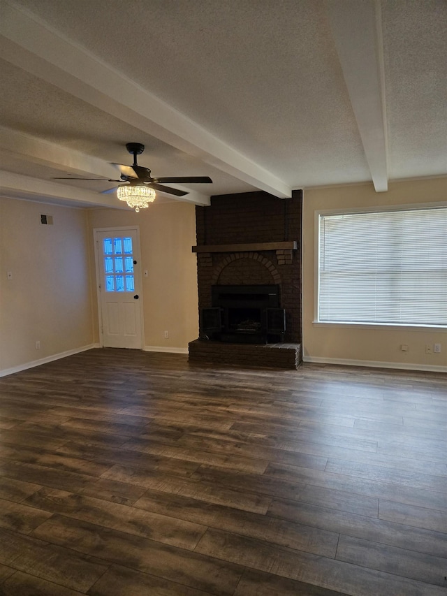 3403 Lynchburg St, Memphis, TN 38134 - unfurnished living room with beamed ceiling, ceiling fan, a textured ceiling, baseboards, and a brick fireplace