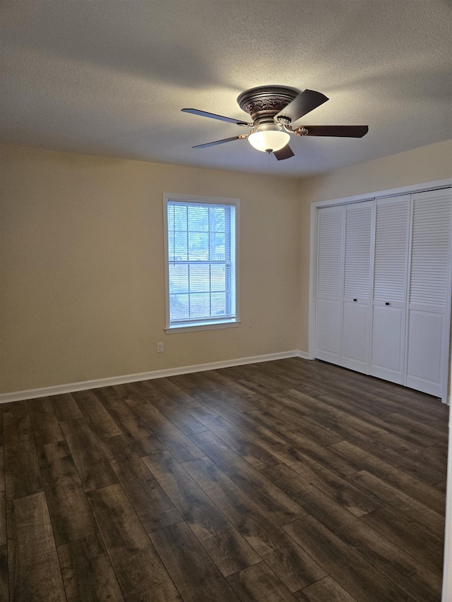 3403 Lynchburg St, Memphis, TN 38134 - unfurnished bedroom with dark wood-type flooring, a textured ceiling, baseboards, a closet, and ceiling fan