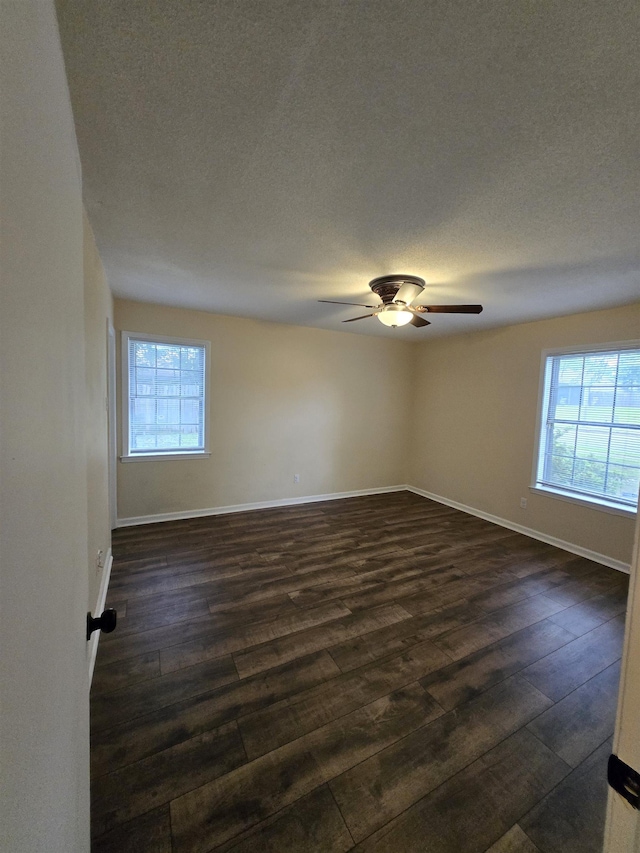3403 Lynchburg St, Memphis, TN 38134 - spare room with plenty of natural light, dark wood finished floors, baseboards, and a textured ceiling