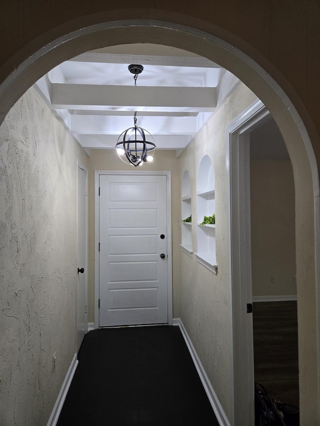 3403 Lynchburg St, Memphis, TN 38134 - doorway featuring arched walkways, beam ceiling, baseboards, a chandelier, and a textured wall