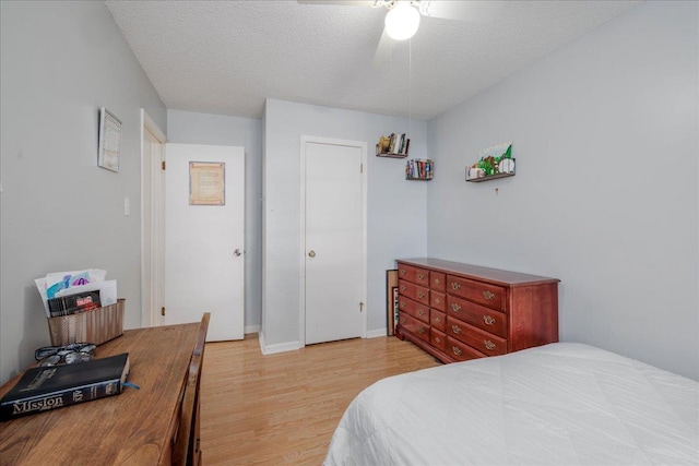 4357 Water Briar Rd, Millington, TN 38053 - bedroom with light wood-style flooring, a textured ceiling, a ceiling fan, and baseboards