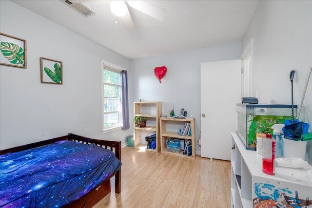 4357 Water Briar Rd, Millington, TN 38053 - bedroom with light wood-style floors, a textured ceiling, and ceiling fan