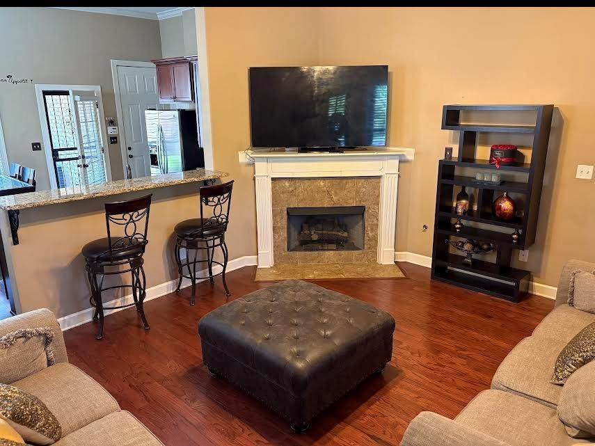 1995 S Bend Dr, Cordova, TN 38016 - living area featuring wood finished floors, a fireplace, and crown molding