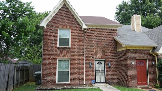 6240 Kirby Downs Dr, Memphis, TN 38115 - traditional home with brick siding, a chimney, and roof with shingles