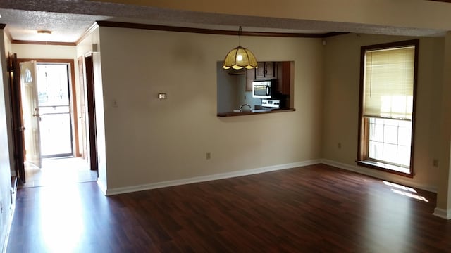 6240 Kirby Downs Dr, Memphis, TN 38115 - unfurnished dining area with dark wood-style flooring, crown molding, baseboards, and a textured ceiling