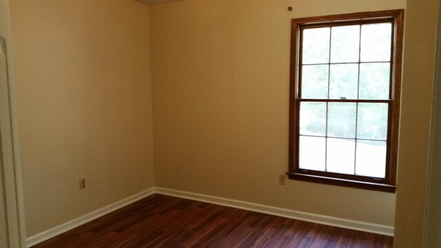 6240 Kirby Downs Dr, Memphis, TN 38115 - unfurnished room with baseboards and dark wood-style floors