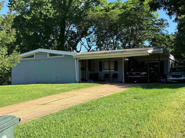 2714 Nix Cv, Memphis, TN 38127 - view of front facade with concrete driveway, a front yard, and a carport