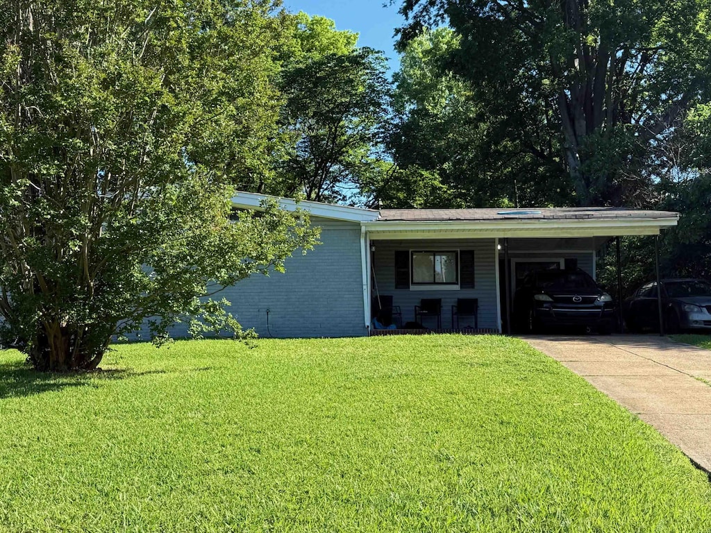 2714 Nix Cv, Memphis, TN 38127 - view of front of property featuring a carport, a front lawn, driveway, and brick siding