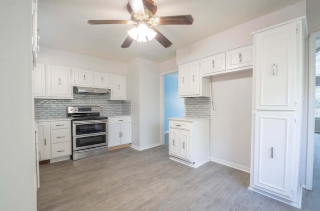 12580 Macon Rd, Tn, TN 38017 - kitchen featuring range with two ovens, under cabinet range hood, tasteful backsplash, and a ceiling fan