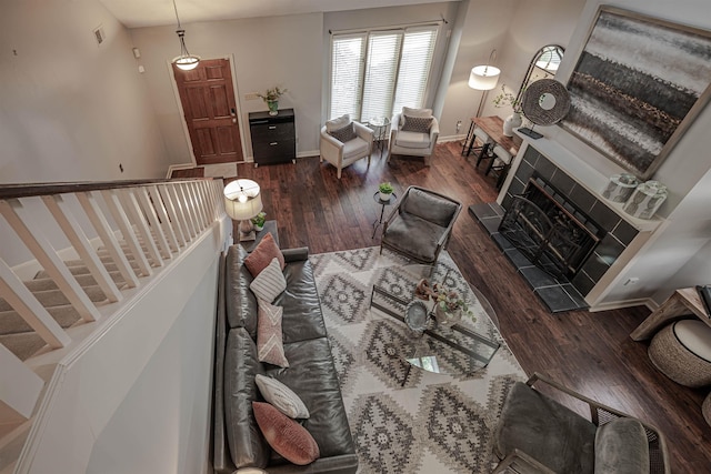 8451 Donegal Cv, Germantown, TN 38139 - living room with wood finished floors, baseboards, a tile fireplace, and stairway