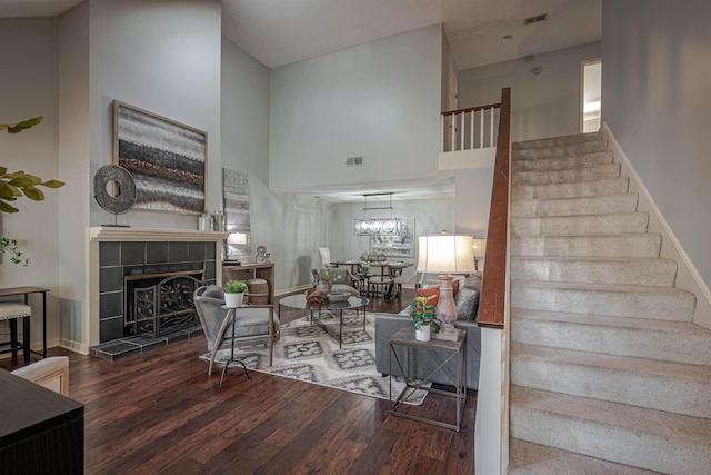 8451 Donegal Cv, Germantown, TN 38139 - living area featuring wood finished floors, stairway, a towering ceiling, a tile fireplace, and baseboards