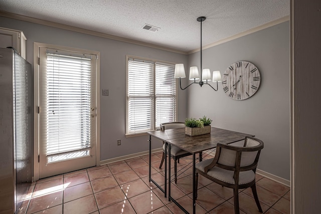 8451 Donegal Cv, Germantown, TN 38139 - dining room featuring a chandelier, a textured ceiling, light tile patterned flooring, crown molding, and baseboards