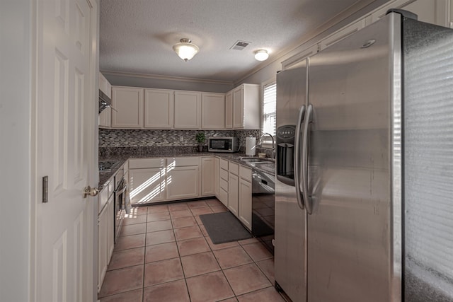 8451 Donegal Cv, Germantown, TN 38139 - kitchen featuring black appliances, a sink, dark countertops, white cabinetry, and a textured ceiling