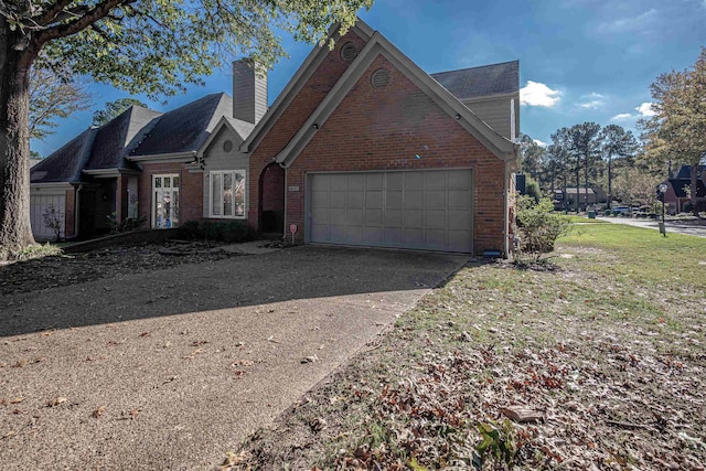 8451 Donegal Cv, Germantown, TN 38139 - traditional-style home with driveway, brick siding, a garage, and a chimney