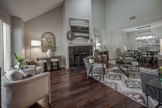 8451 Donegal Cv, Germantown, TN 38139 - living area with a tiled fireplace, high vaulted ceiling, wood finished floors, and baseboards