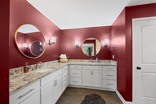 1002 New York St, Memphis, TN 38104 - full bath with double vanity, wood finished floors, and baseboards