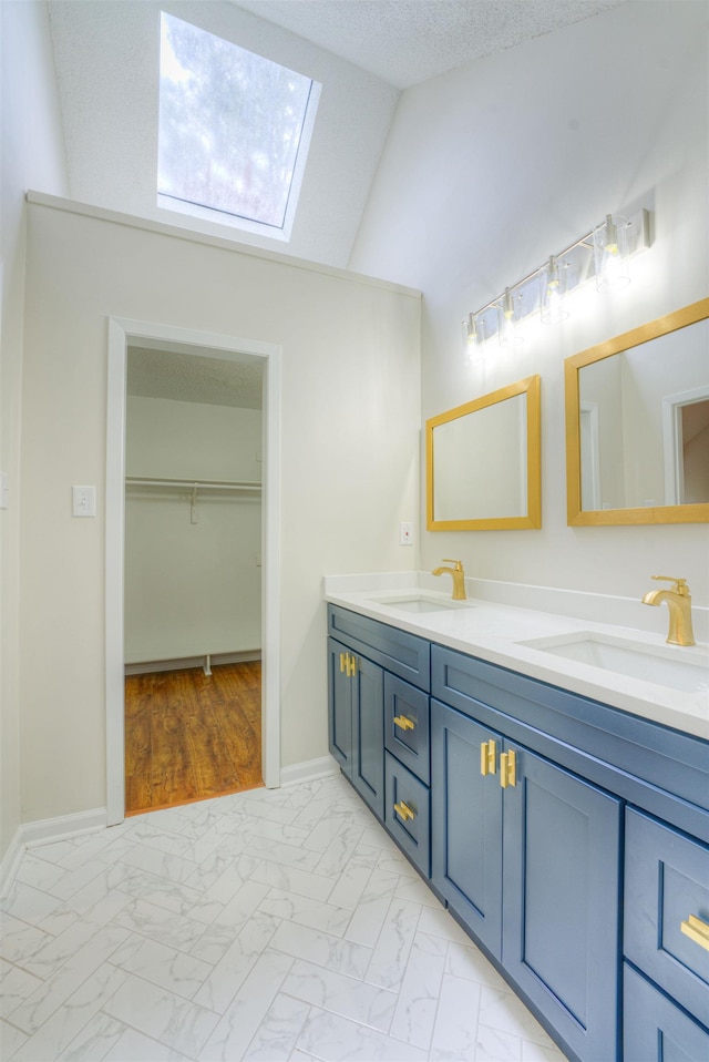1823 Allenby Green Dr Unit 6, Germantown, TN 38139 - bathroom with a skylight, marble finish floors, lofted ceiling, double vanity, and a walk in closet