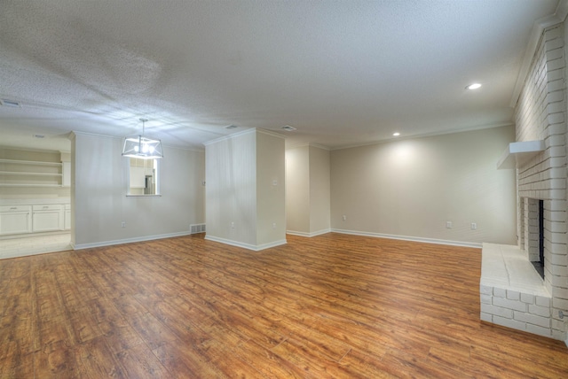 1823 Allenby Green Dr Unit 6, Germantown, TN 38139 - unfurnished living room with light wood-style flooring, a fireplace, ornamental molding, baseboards, and recessed lighting