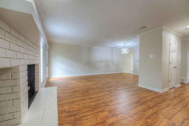 1823 Allenby Green Dr Unit 6, Germantown, TN 38139 - unfurnished living room with ornamental molding, wood finished floors, baseboards, a textured ceiling, and a brick fireplace