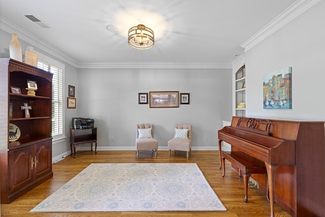 9245 Forest Estates Cv, Germantown, TN 38139 - sitting room with ornamental molding, light wood finished floors, a desk, baseboards, and built in shelves