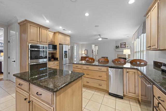 9245 Forest Estates Cv, Germantown, TN 38139 - kitchen featuring appliances with stainless steel finishes, light tile patterned flooring, a ceiling fan, a peninsula, and crown molding