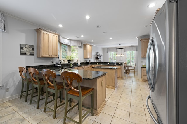 9245 Forest Estates Cv, Germantown, TN 38139 - kitchen featuring freestanding refrigerator, a peninsula, recessed lighting, light tile patterned flooring, and light brown cabinetry