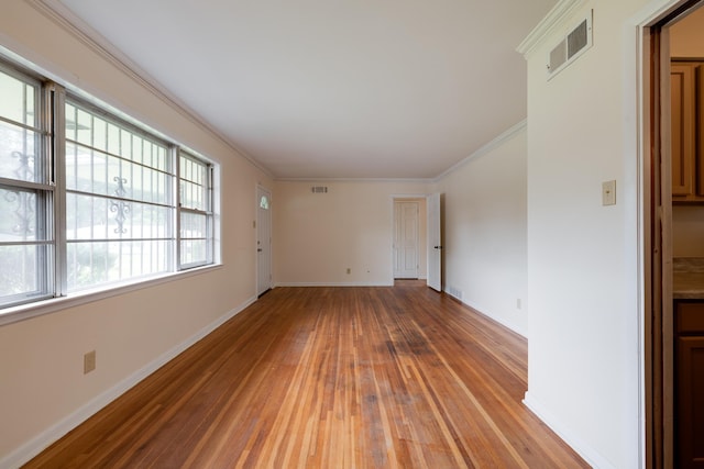 5151 Canton Dr, Memphis, TN 38116 - empty room with light wood finished floors, baseboards, and ornamental molding