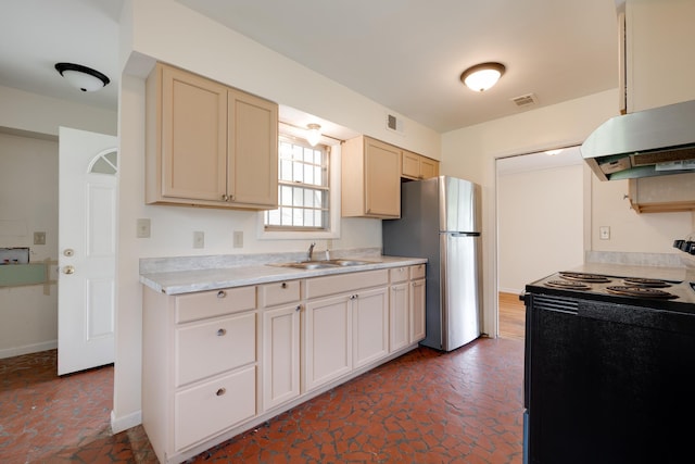 5151 Canton Dr, Memphis, TN 38116 - kitchen with black / electric stove, under cabinet range hood, a sink, freestanding refrigerator, and light countertops