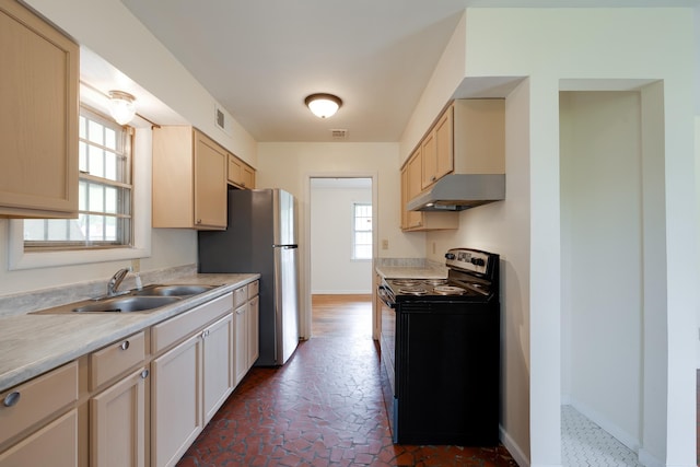 5151 Canton Dr, Memphis, TN 38116 - kitchen featuring black range with electric stovetop, a sink, under cabinet range hood, light countertops, and freestanding refrigerator