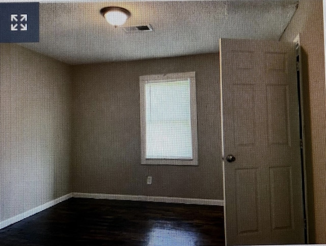950 Melrose St, Memphis, TN 38114 - spare room featuring dark wood-type flooring and baseboards