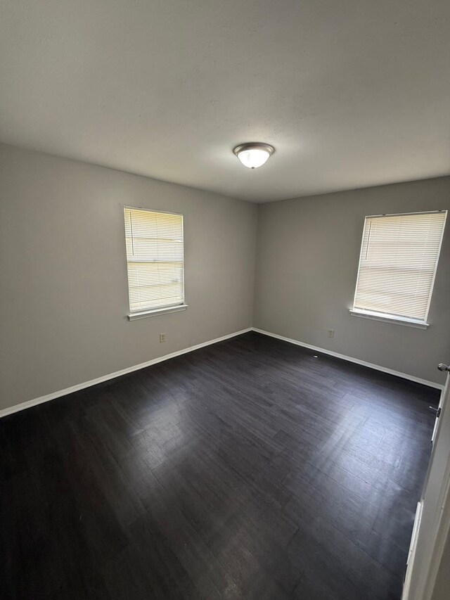 3223 Boone St, Memphis, TN 38127 - unfurnished room with dark wood finished floors and baseboards