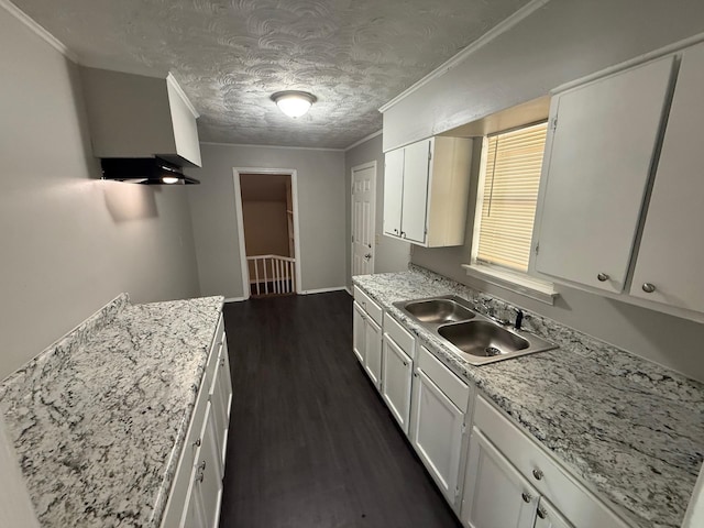 3223 Boone St, Memphis, TN 38127 - kitchen featuring a sink, ornamental molding, white cabinetry, dark wood-type flooring, and a textured ceiling