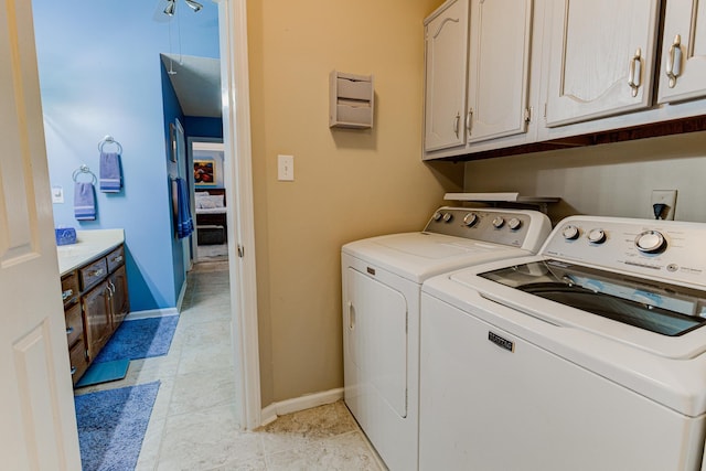3120 Caledonia Rd, Memphis, TN 38119 - washroom featuring separate washer and dryer, baseboards, cabinet space, and light tile patterned floors
