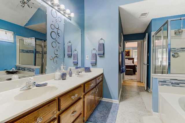3120 Caledonia Rd, Memphis, TN 38119 - ensuite bathroom featuring a shower stall, a garden tub, double vanity, and baseboards