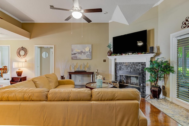 3120 Caledonia Rd, Memphis, TN 38119 - living area featuring a high end fireplace, ceiling fan, wood finished floors, crown molding, and vaulted ceiling