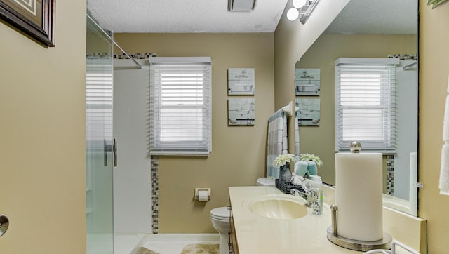 3120 Caledonia Rd, Memphis, TN 38119 - bathroom with a stall shower, healthy amount of natural light, a textured ceiling, toilet, and vanity