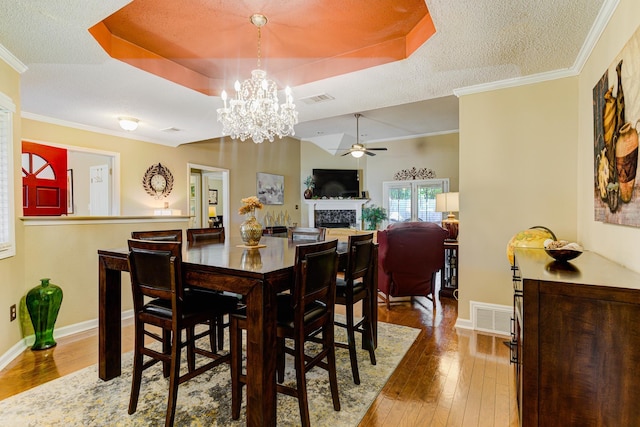 3120 Caledonia Rd, Memphis, TN 38119 - dining area featuring a tray ceiling, wood-type flooring, a ceiling fan, baseboards, and a textured ceiling